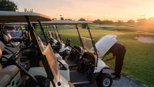 Golf cart maintenance on a course with technician inspecting battery connections, highlighting troubleshooting and fleet reliability.