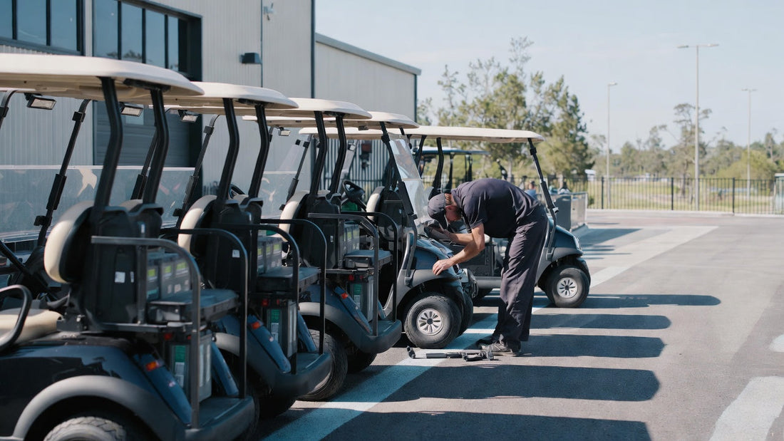 Golf carts being inspected in a maintenance area, highlighting professional fleet preparation and pre-season servicing.