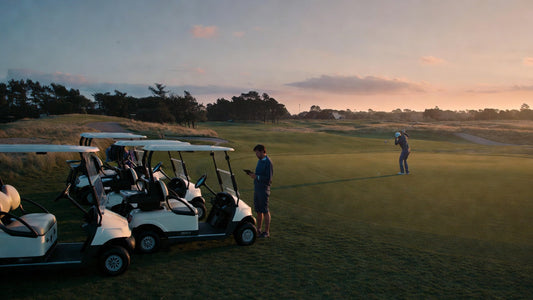 Professional golf cart fleet on a course with manager inspecting vehicles, representing smart buying decisions and commercial fleet management.
