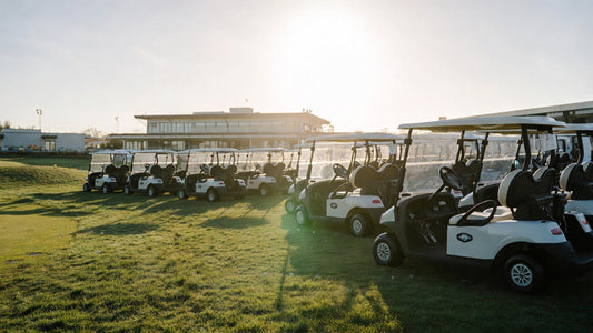A fleet of golf carts lined up on a premium golf course, representing large-scale procurement and modern fleet management.